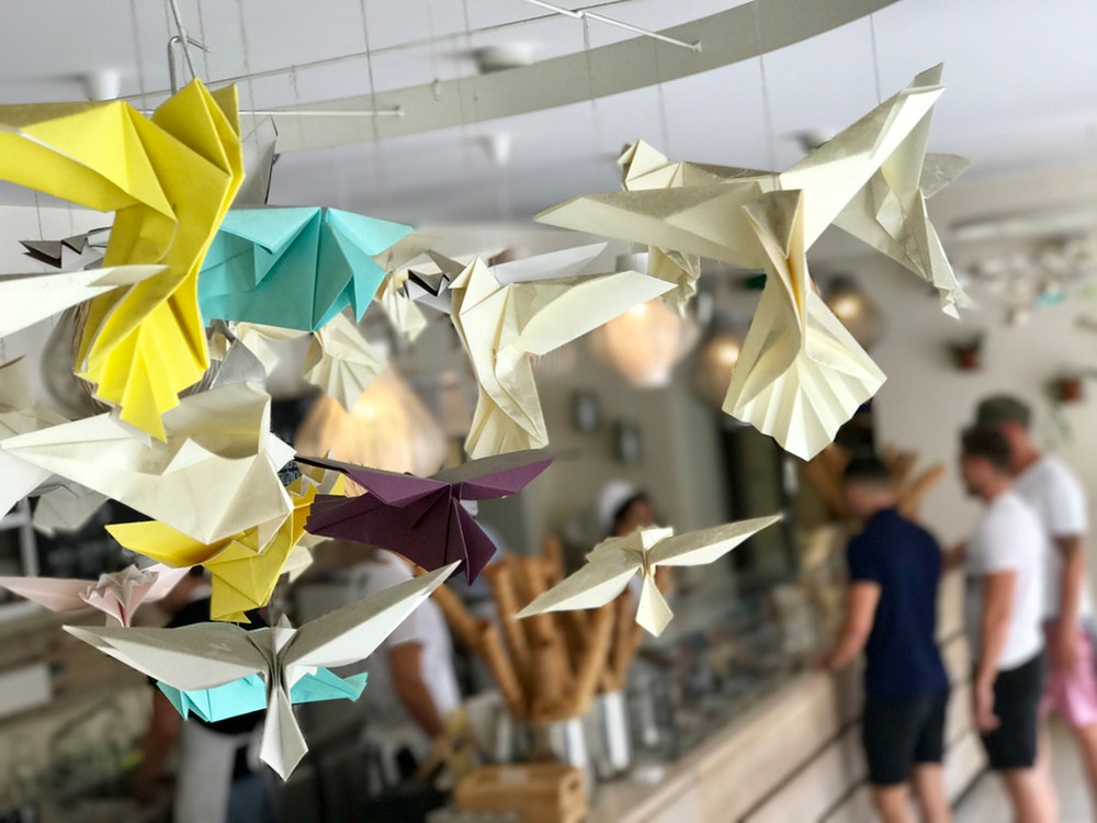 white, yellow, and teal paper bird decorations
