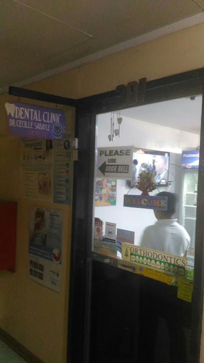 Dentist in Iligan: Office entry with signs Please use doorbell, Orthodontics, and a visible waiting area inside.