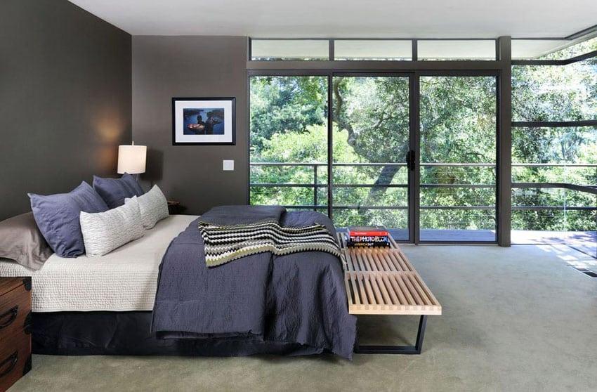 masculine-bedroom-with-expansive-wrap-around-window-viewsand-dark-gray-paint.jpg
