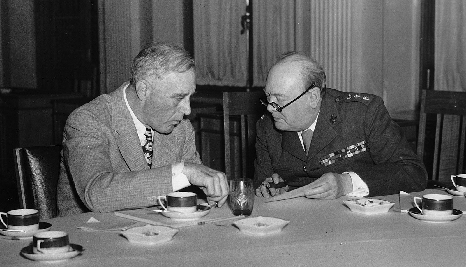 Alt-Text: A photograph of Winston Churchill sitting with Franklin D. Roosevelt at the Yalta Conference