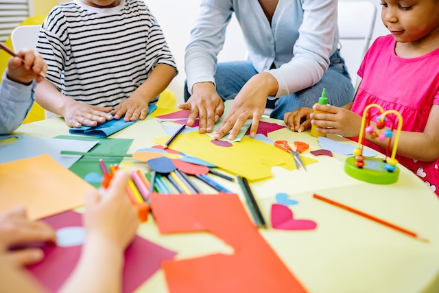 children doing arts and crafts activity on table