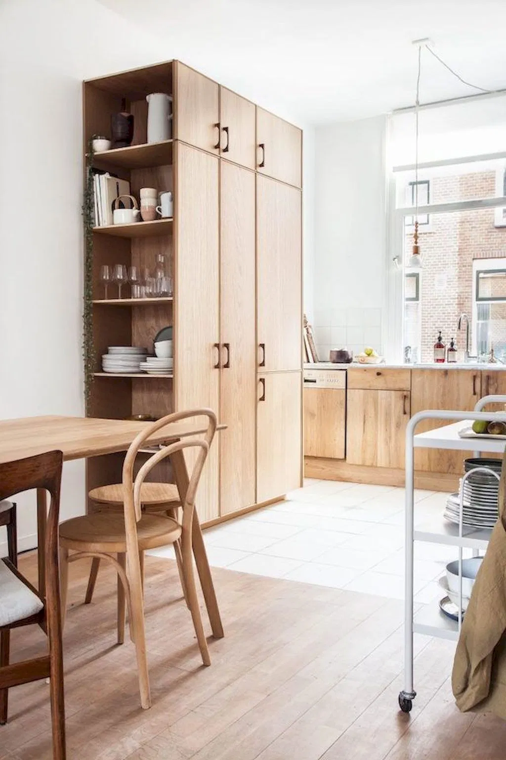 minimalist kitchen design with natural wood cabinets, wood floors and wood dining table