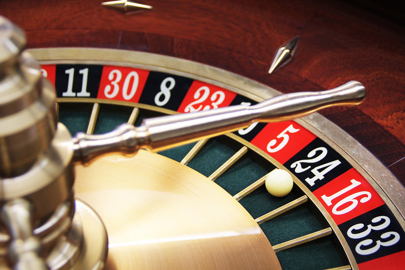 A casino roulette wheel with the white ball resting in the black number 24 section after a bet was placed using the latest casino bonuses