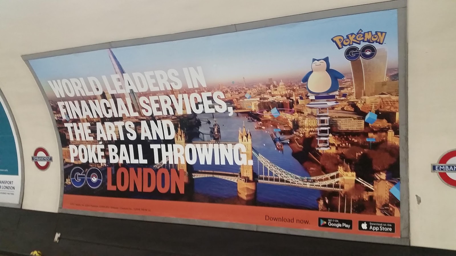 Pokemon GO's billboard in London's subway, with the text, "World leaders in financial services, the arts and Poke ball throwing. GO London"