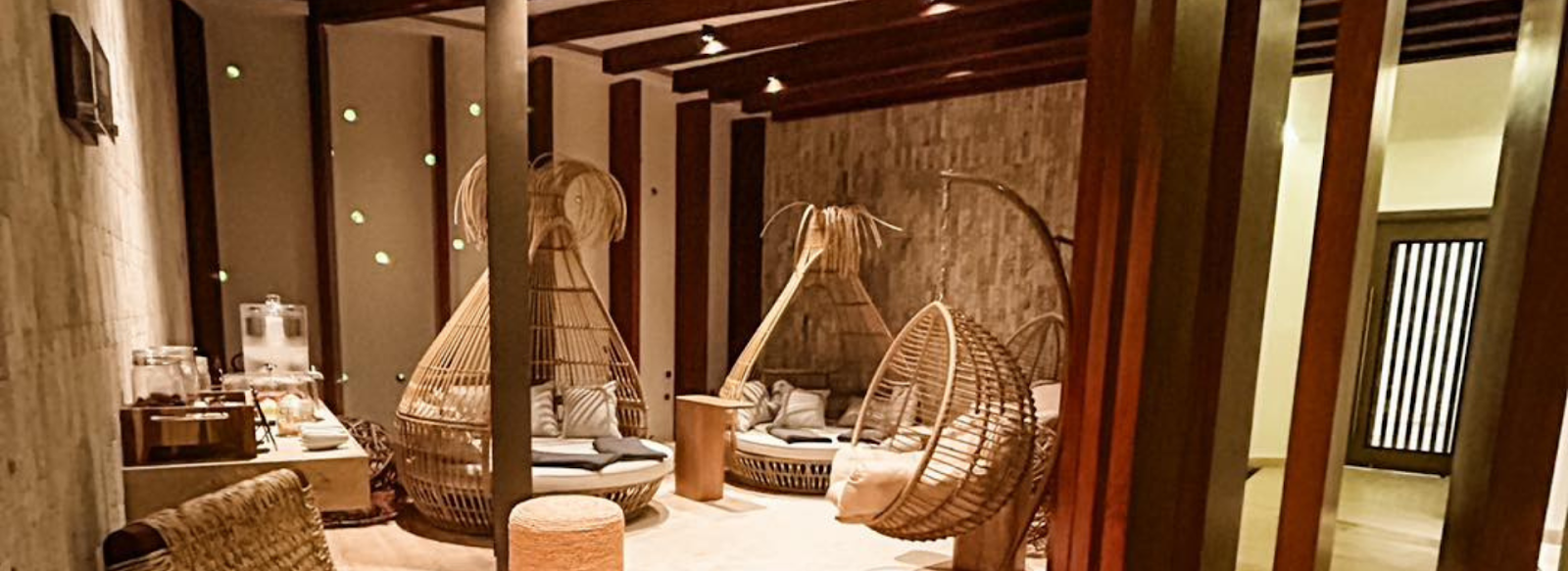 Spa sitting area with hanging swings and day beds at an all inclusive resort