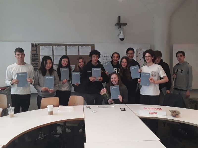 With Olivia sitting at center, students pose with their copies of the published law review