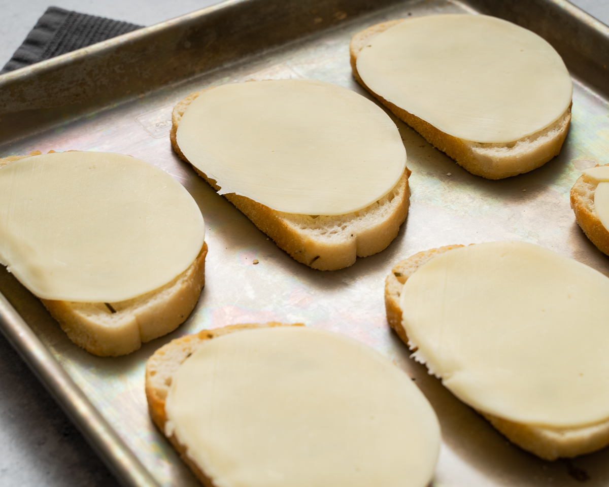 slice of bread with provolone cheese on top