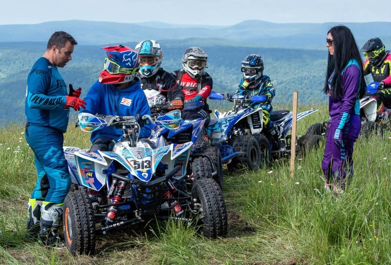 Yamaha GNCC instructor leads group on trail, providing riding instructions