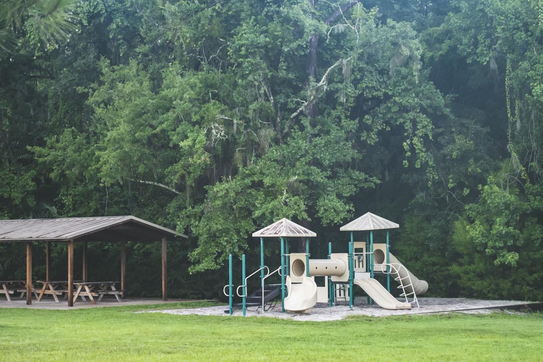 Playground and pavilion next to trees at Rainbow Springs State Park