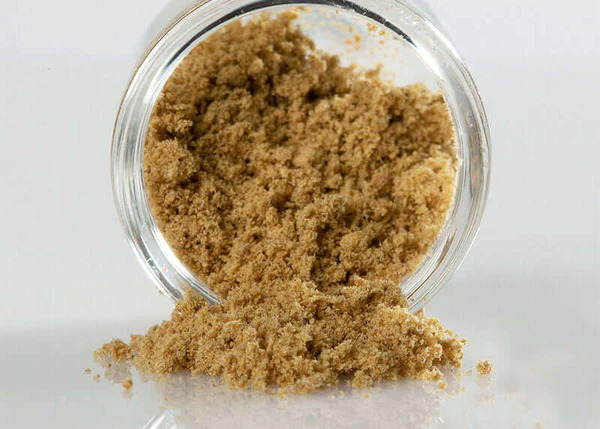 Crumbly, CBD kief spilling out of a mason jar