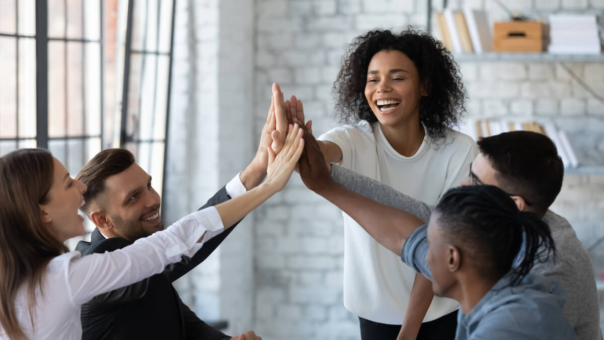 HR automation: happy team high-fiving each other