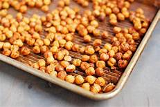 Picture of roasted chickpeas on a baking sheet. Chickpeas are a nutritious and delicious snack packed full of vitamins and minerals.