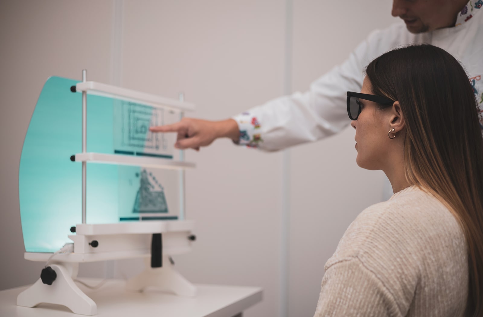 A young woman undergoing vision therapy at the optometrist's office