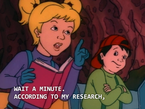 DA from The Magic School Bus holding a book saying "Wait a minute. According to my research," with Ralphie in the background with his arms crossed across his chest.