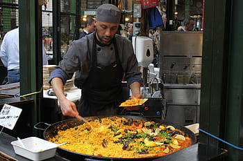 Chef serving paella