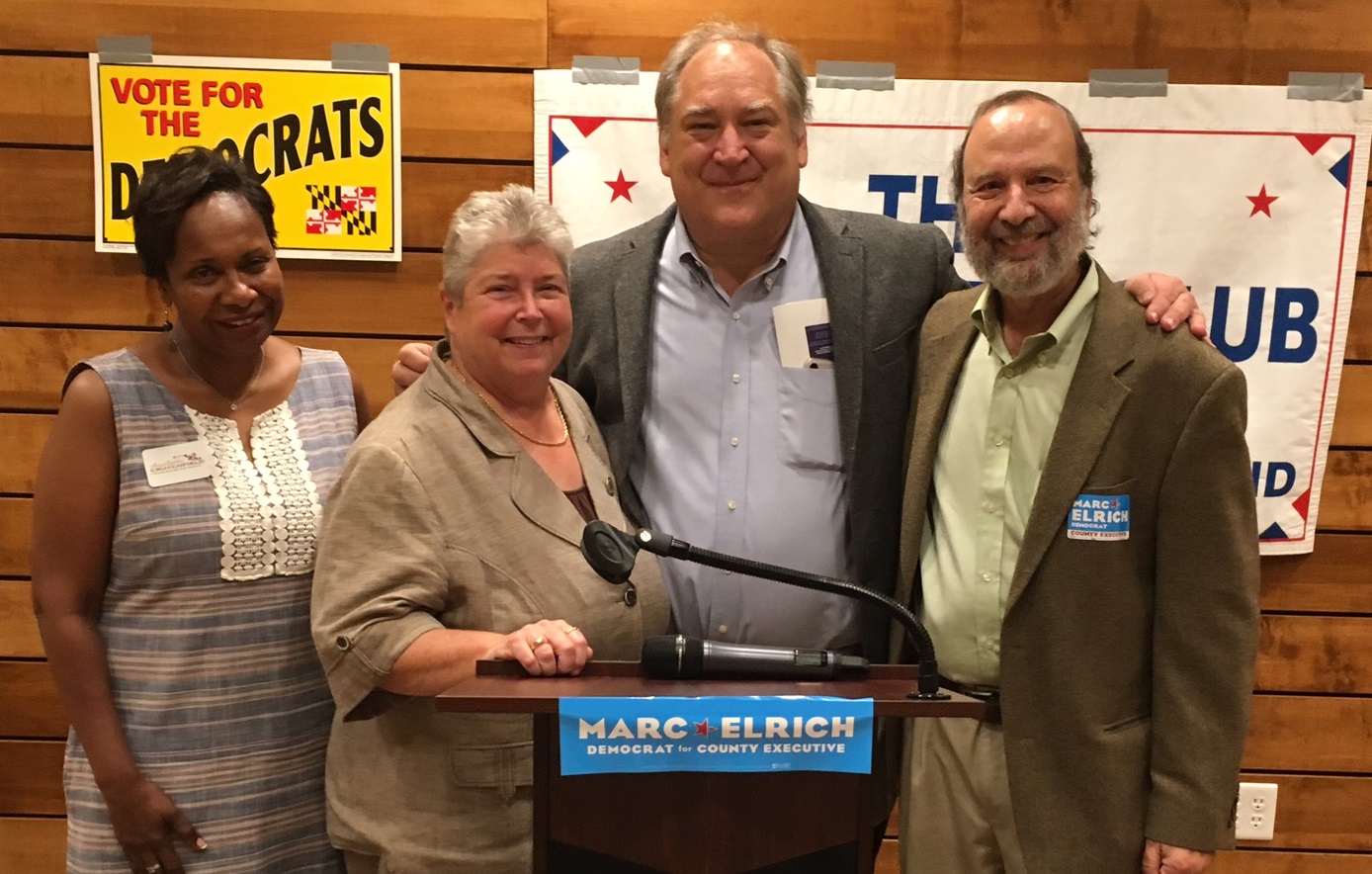 Four people stand together including Charlotte Crutchfield, Bonnie Cullison, Marc Elrich