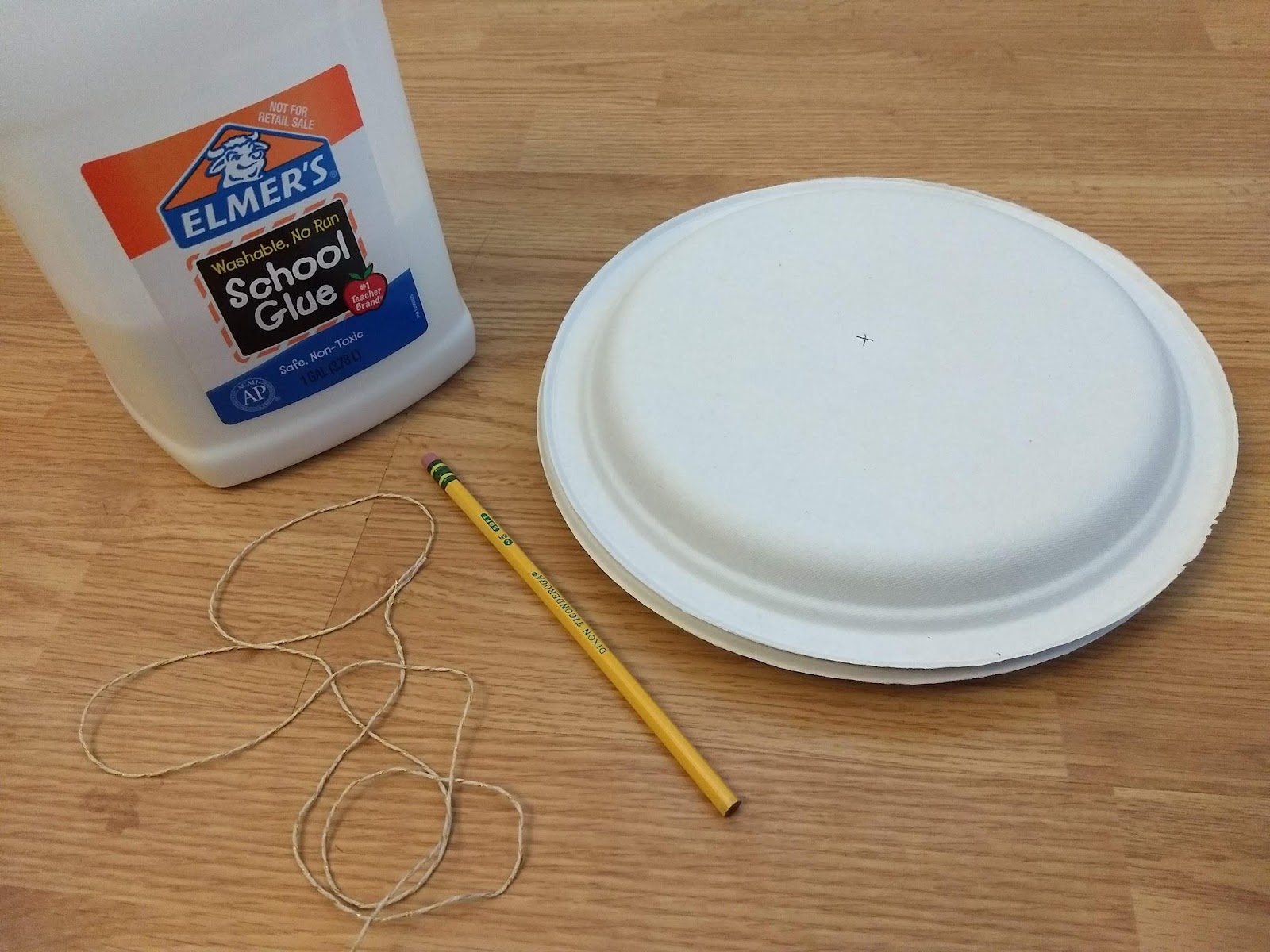 Elmer's glue, a pencil, two paper plates, and the string to pull your wheel and axle.