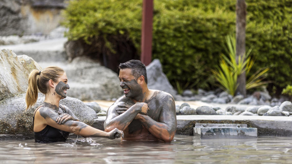 People sitting in Mud Bath at Hells Gate pools, Rotorua