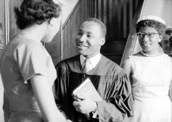 Martin Luther King Jr. Photo Gallery: Reverend Martin Luther King, Jr. speaks with people after delivering a sermon on May 13, 1956 in Montgomery, Alabama. (Photo by Michael Ochs Archives/Getty Images)