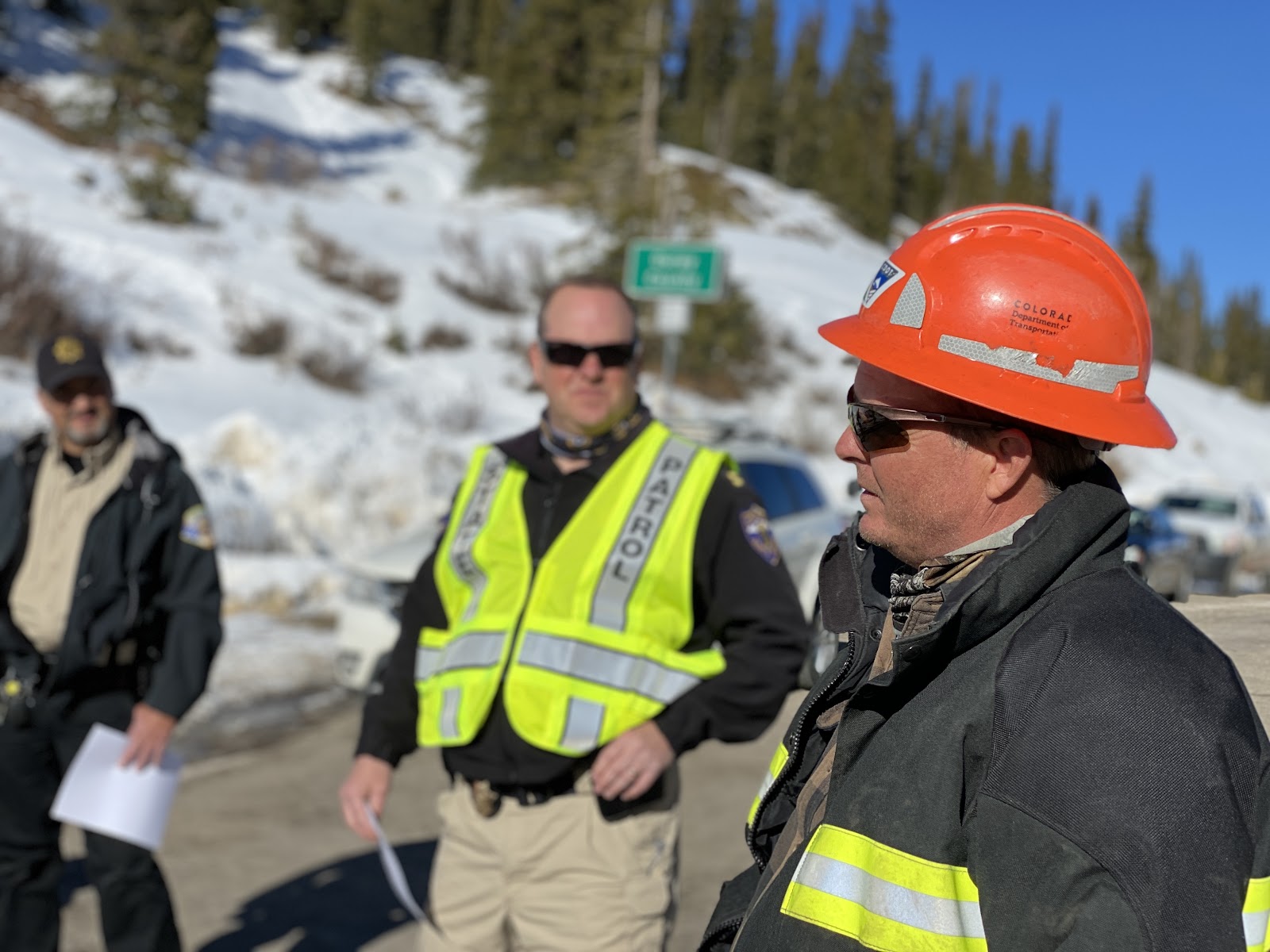 CDOT maintenance personnel talk with law enforcement officers at the summit of US 550 Red Mountain Pass