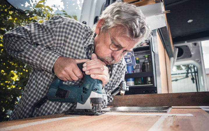 A man doing construction work to his RV