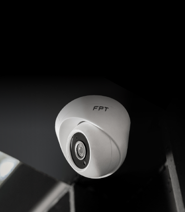 A white camera on a black surfaceDescription automatically generated with low confidence