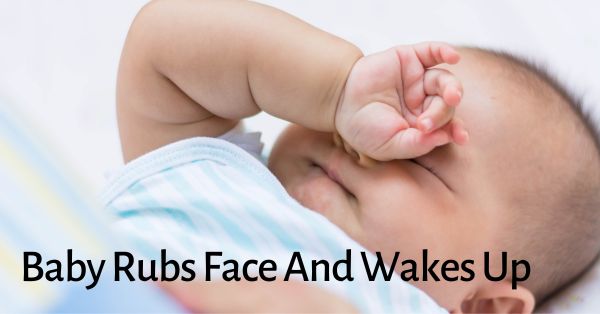 baby rubs face and wakes up