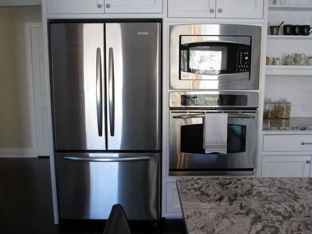 single wall oven next to the refrigerator