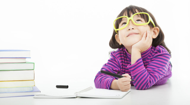 little girl  thinking or dreaming during preparing homework