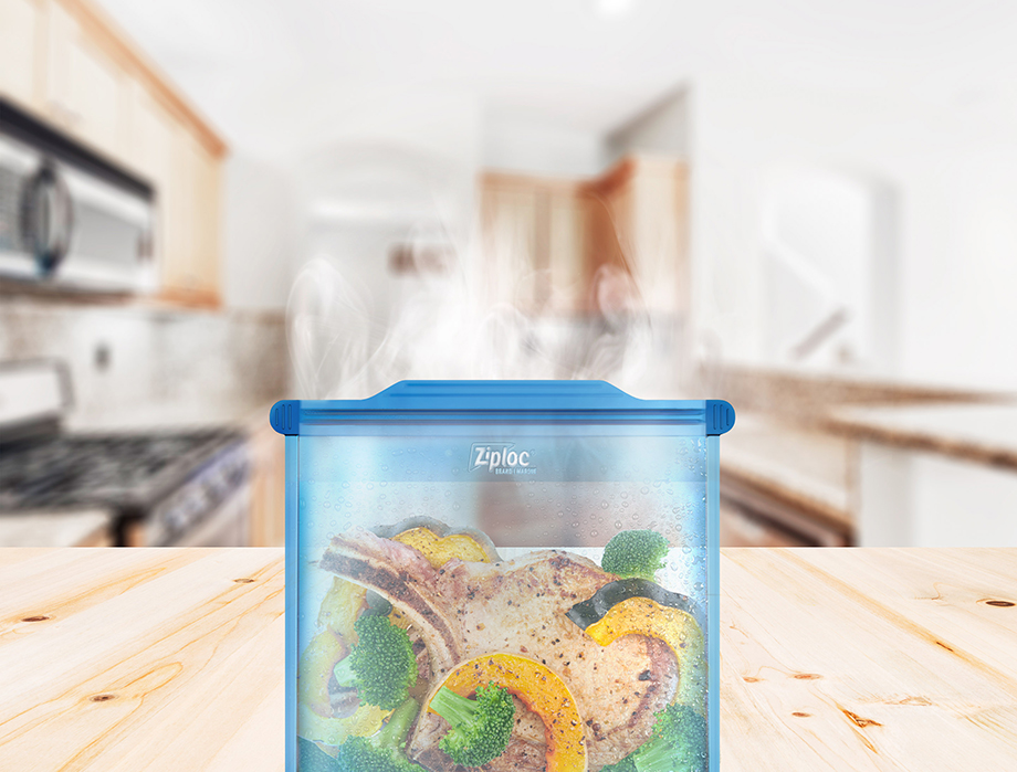 Image of pork chops and vegetables inside Ziploc Endurables product set on a wooded kitchen countertop. Image captured by Chicago based food photographer Morgan Ione.