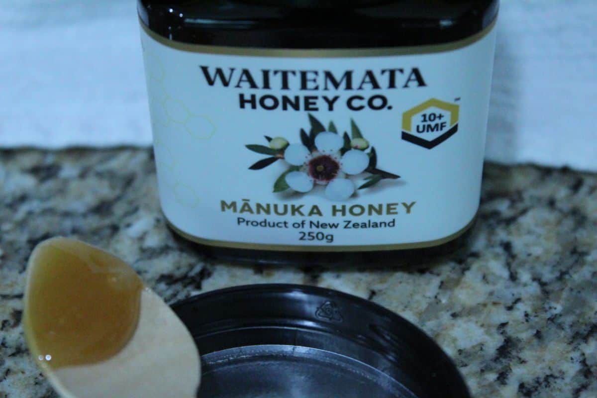 waitemata bottle and manuka honey on spoon