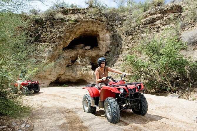 An ATV rider smiling while riding through the Sonoran Desert