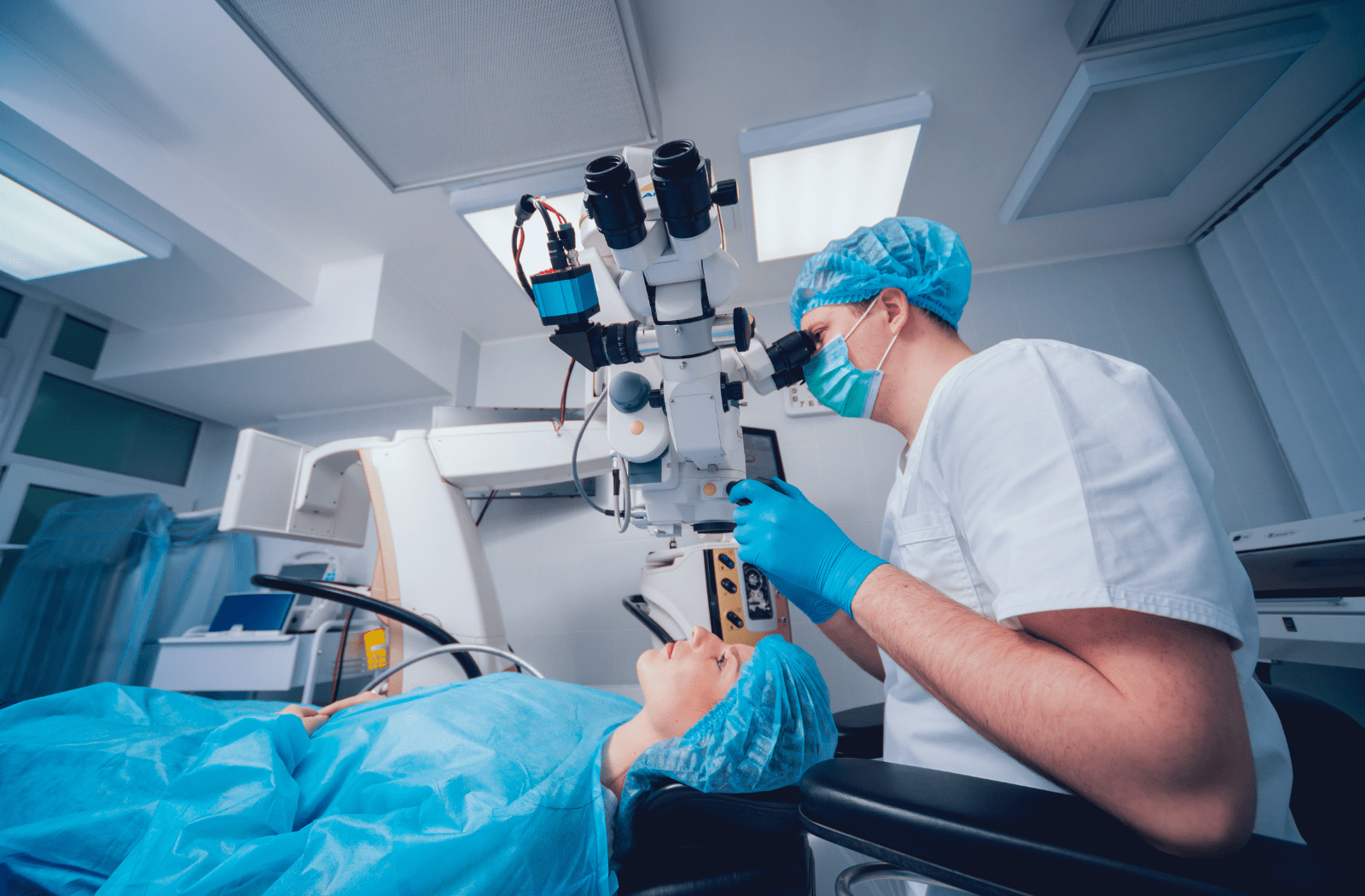 A surgeon preparing for laser eye surgery on a female patient
