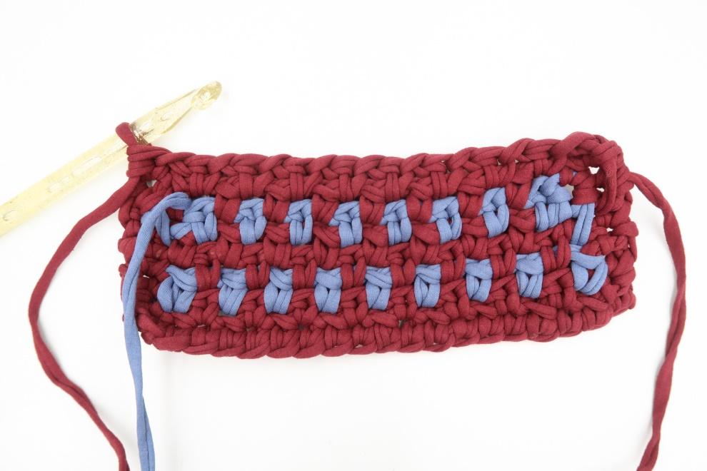 closeup of crochet hook working on potholder