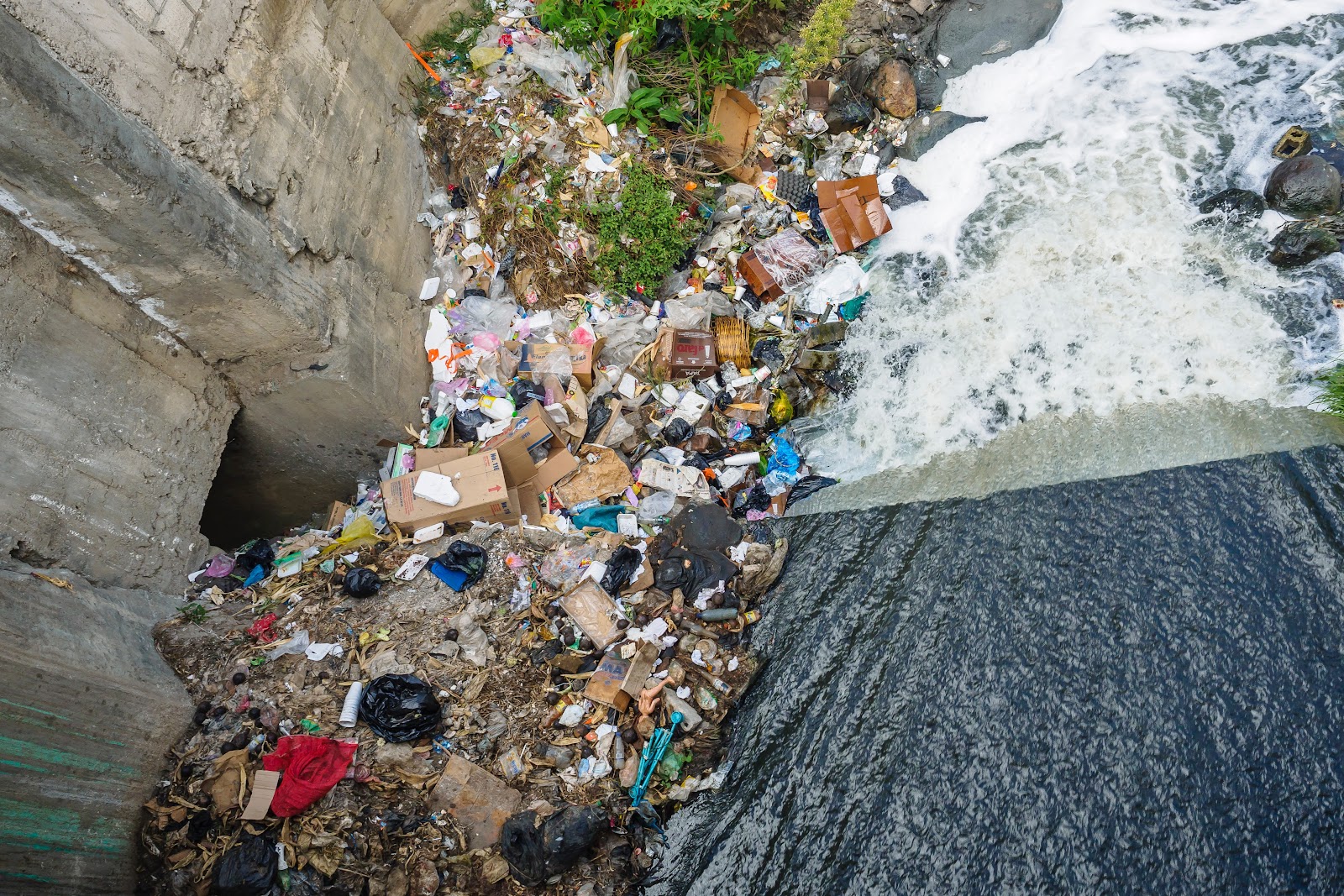 Over flowing garbage into our streams by alexander-schimmeck on unsplash