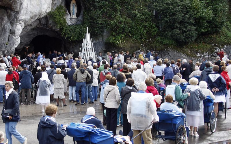 Pilgrims queue to visit the grotto at Lourdes (AP)