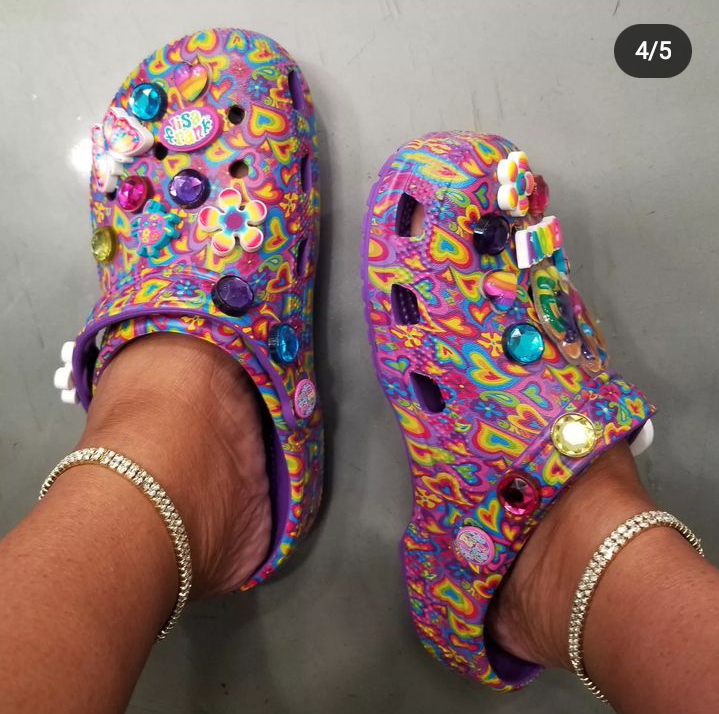 Full view of a lady pairing her lisa frank crocs with leg anklets