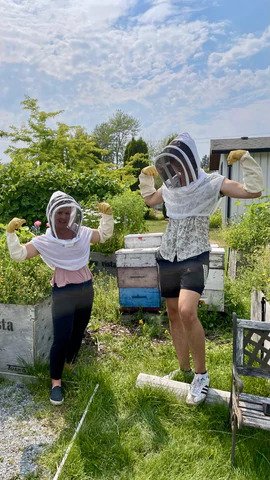 Guests in beekeeper gear flexing their muscles at Meadow Vista Honey Wines