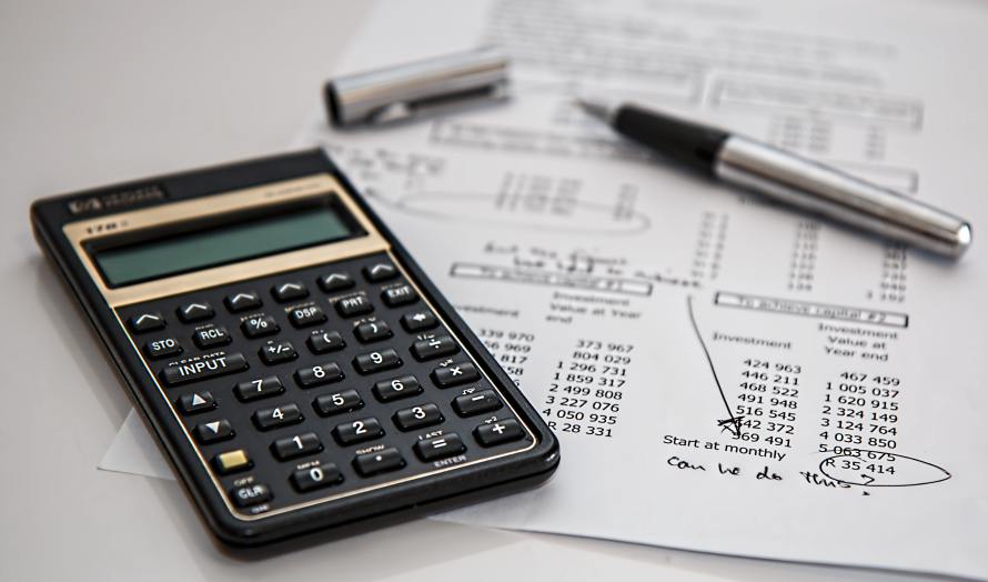 a calculator on top of a sheet of calculations