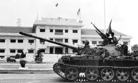 A soldier perched on a tank of the North Vietnamese Army (NVA) in Saigon, as the city falls into the hands of communist troops.