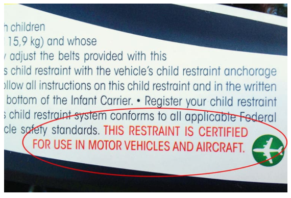 a sticker appearing on car seats approved by federal aviation authority for flying. 