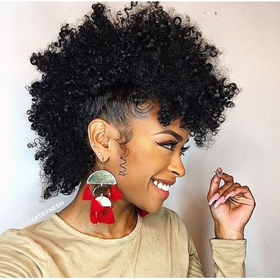 a beautiful naturalista smiling with her frohawk for styling natural short hair