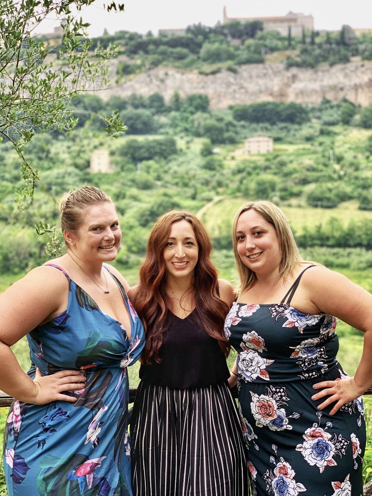 3 women posing in front of mountains in Orvieto, Italy.