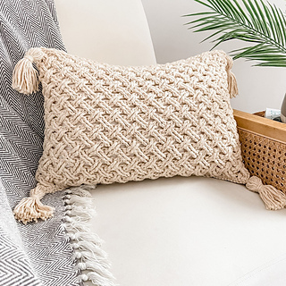 cream celtic weave crochet pillow on chair