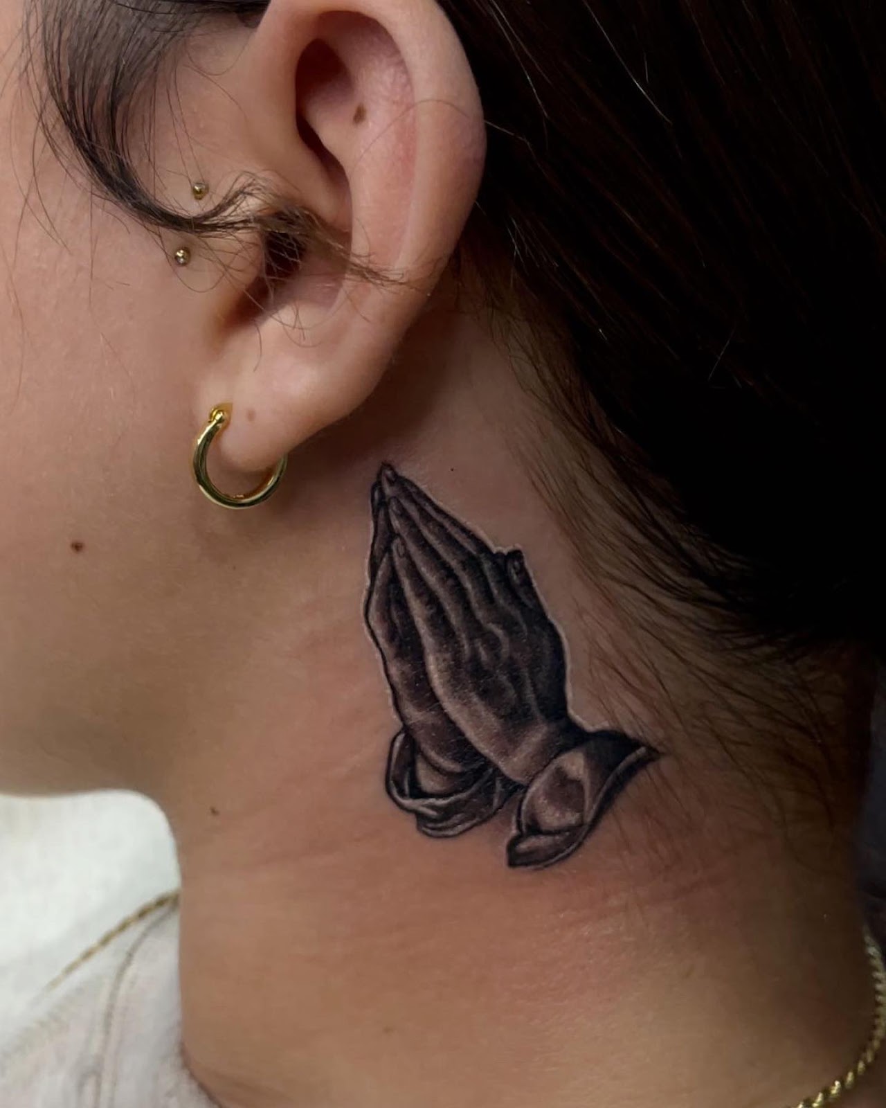 Praying Hands Behind The Ear Tattoo