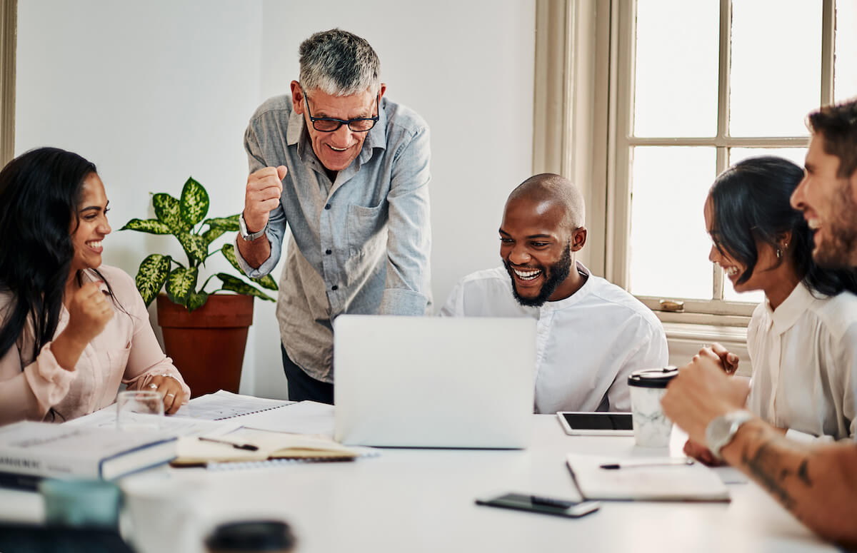 Clinical documentation: excited employees having a meeting