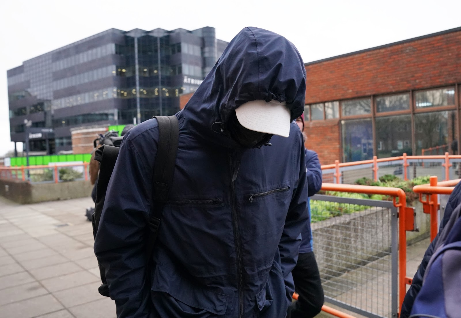 Watts covered his face as he appeared at Uxbridge Magistrates' Court today