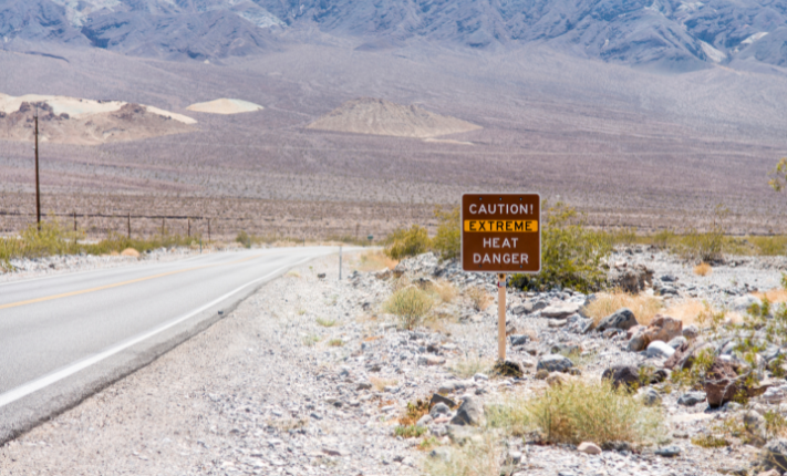 Extreme heat cautionary sign on side of road