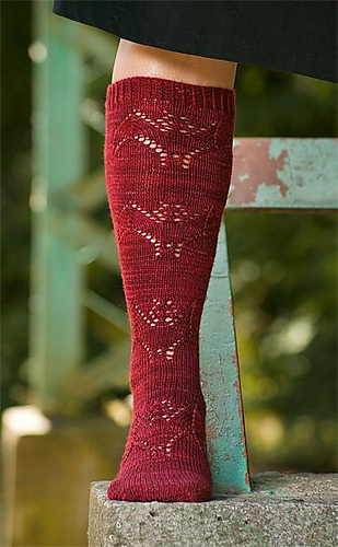 person wearing red knee high socks with bat design