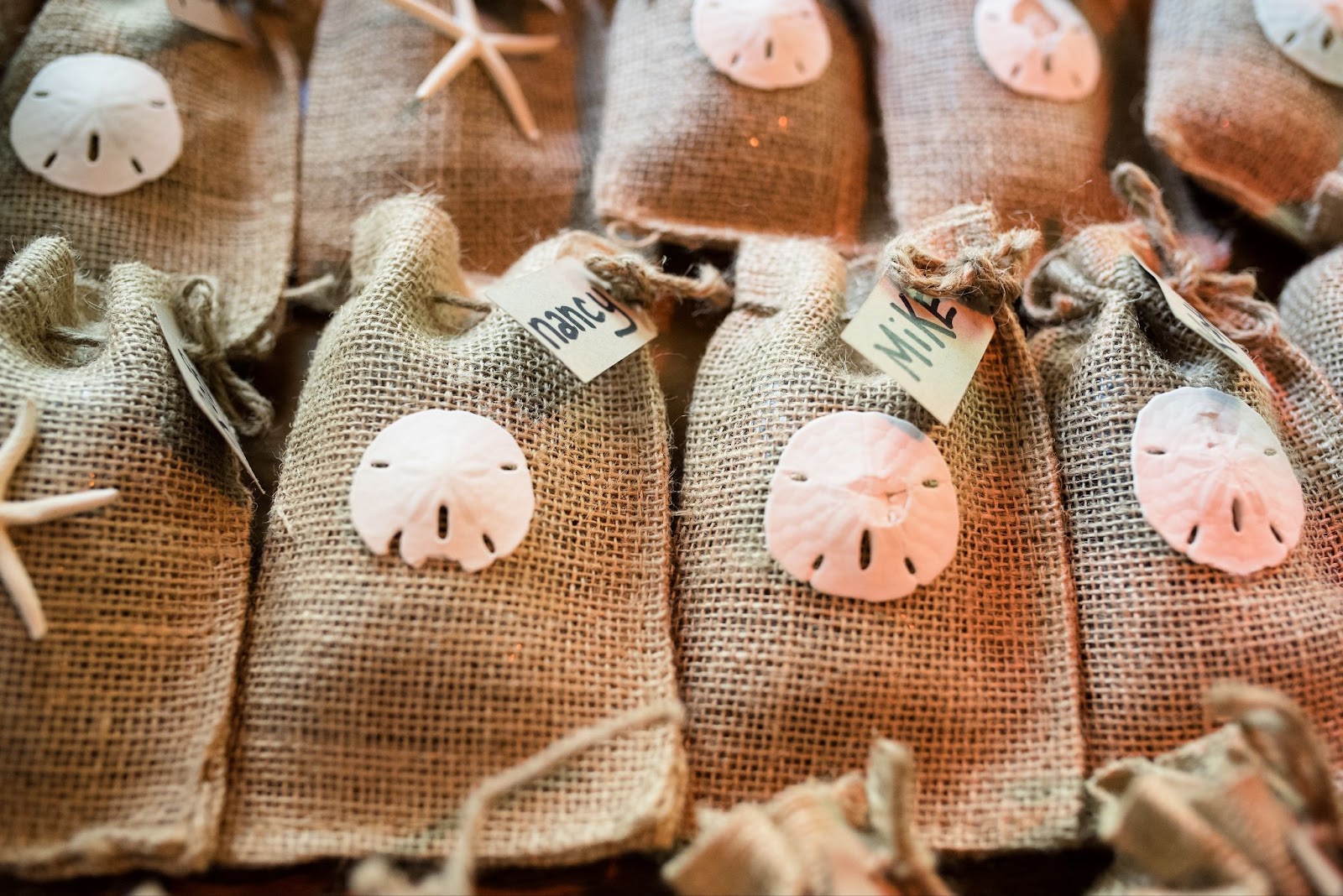 tropical destination wedding gift bags with a sand dollar or starfish on the front